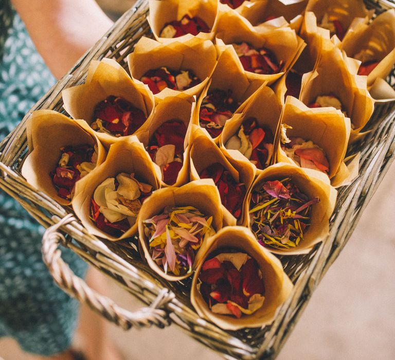 Dried floral confetti in paper cones in a wicker basket  | Story + Colour