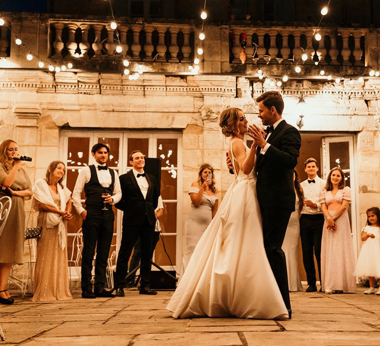 Outdoor first dance at Chateau Lagorce with festoon lights 