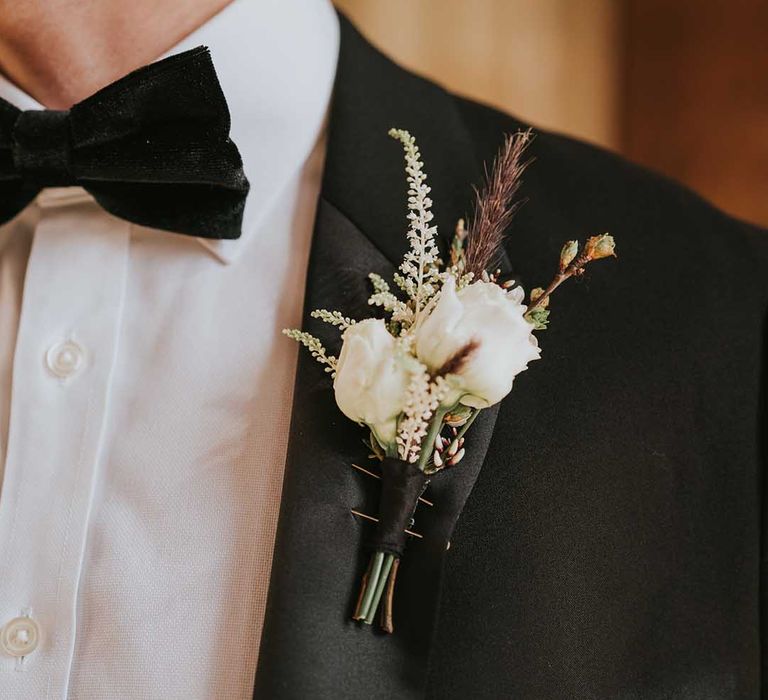 Delicate white rose grooms buttonhole for monochrome wedding at Bodleian Library 