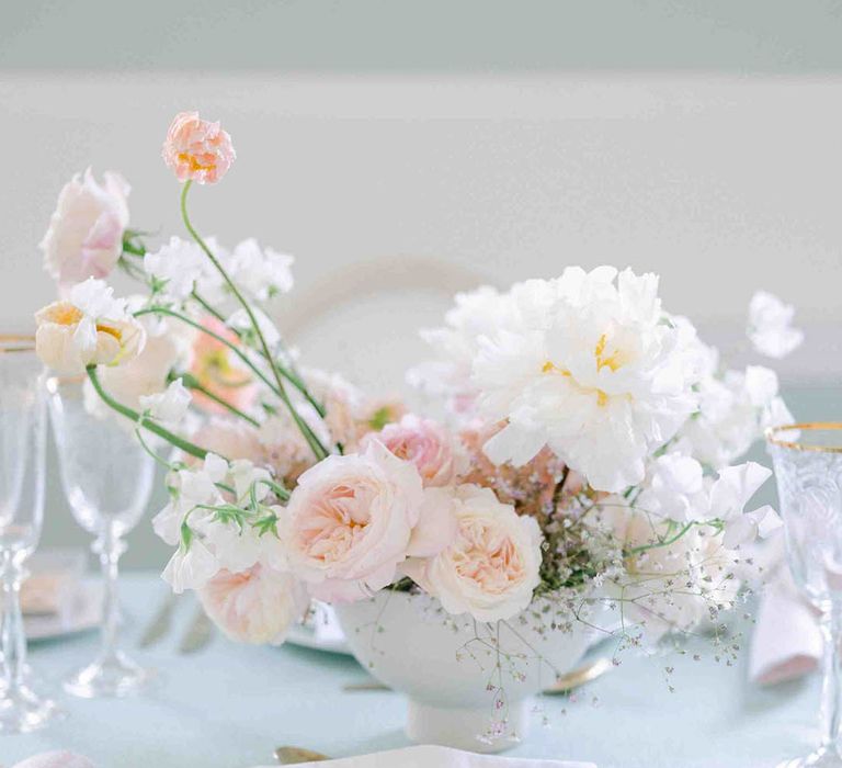 Place setting with roses, peonies, Icelandic poppies, sweet peas, scabious, foxglove, and snapdragon floral centrepiece 