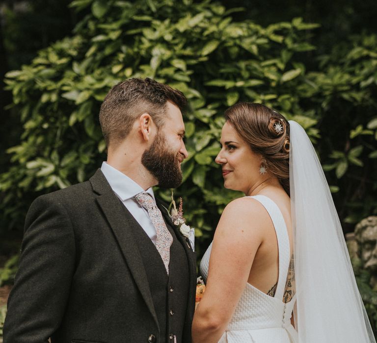 Bride with pinned updo and star hair accessory with matching earrings