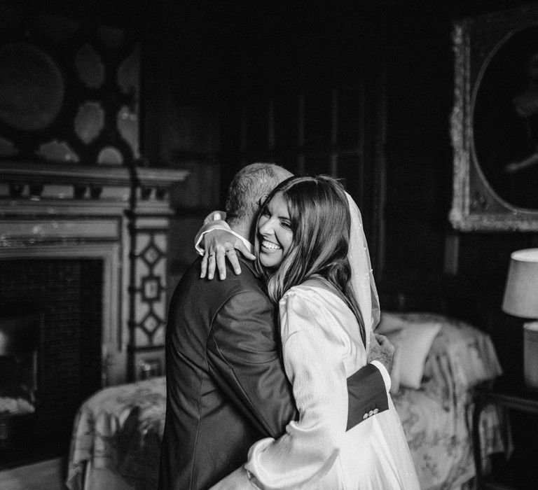 Bride hugs her father on her wedding day