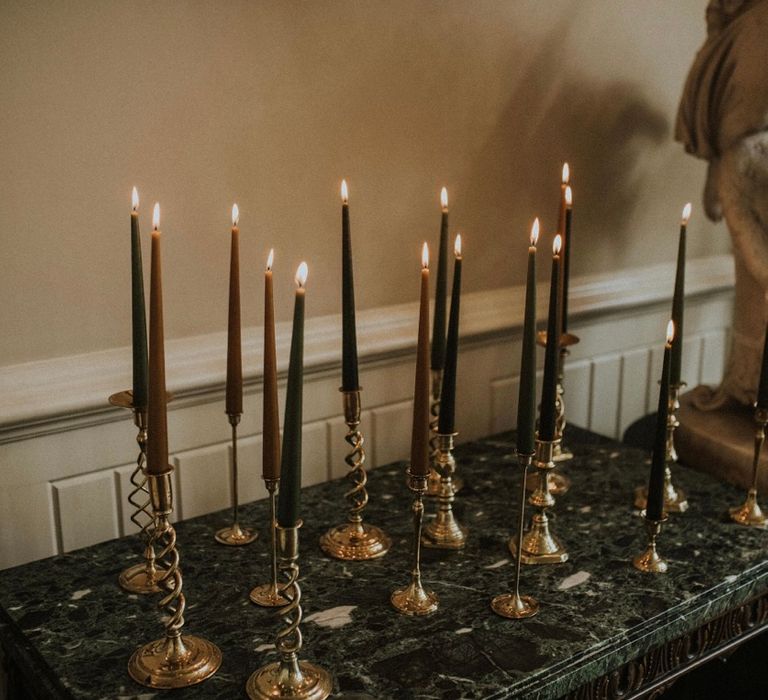 Candles set on marble mantlepiece 