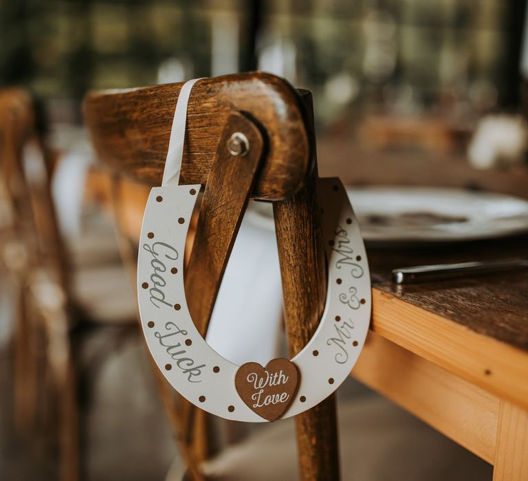 White good luck horseshoe chair hanging for rustic wedding