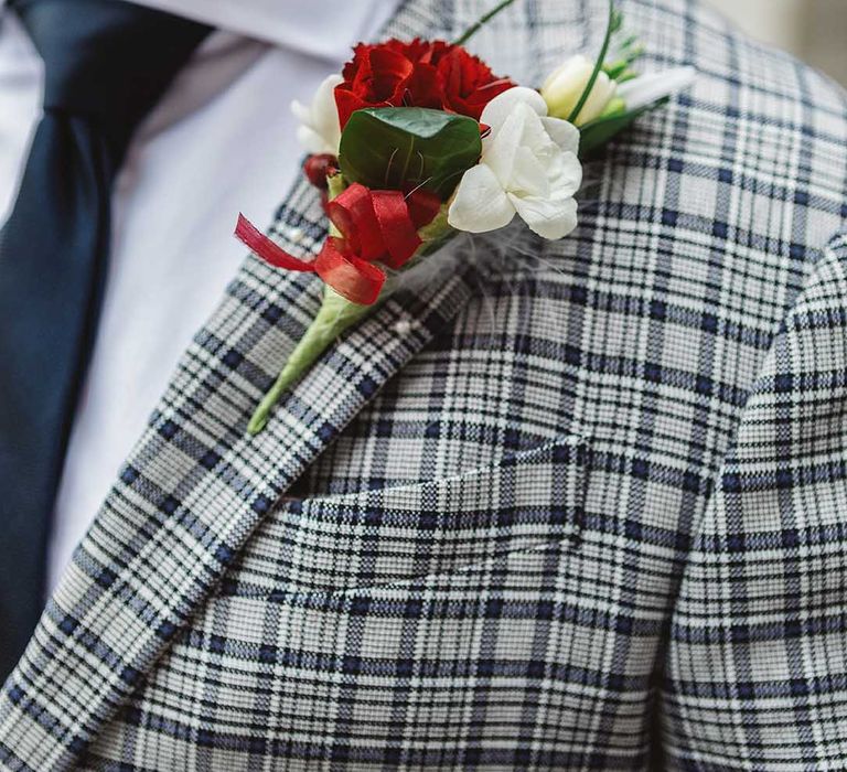 Floral buttonhole with white and red blooms 