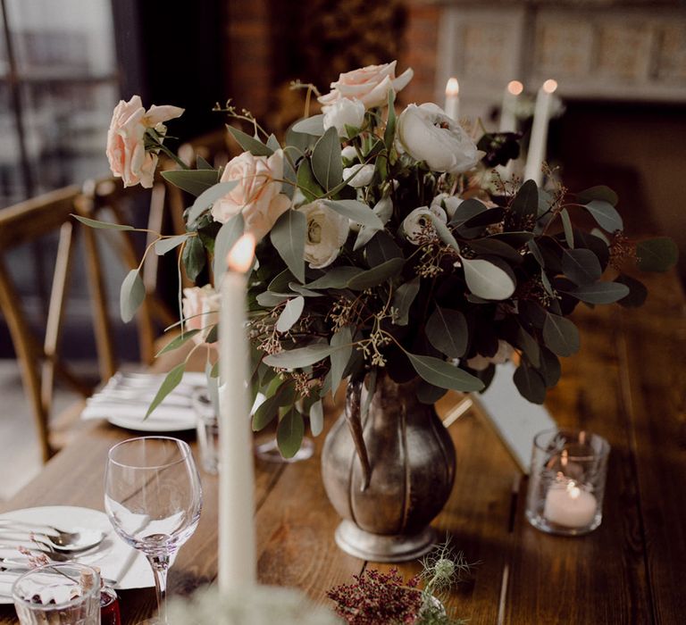 Pink, white and deep red wedding flower arrangements for table settings with white candles