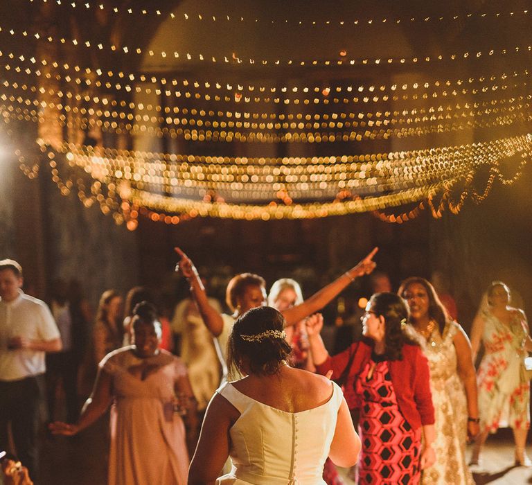 Bride makes her way onto the dance floor and dances with guests 