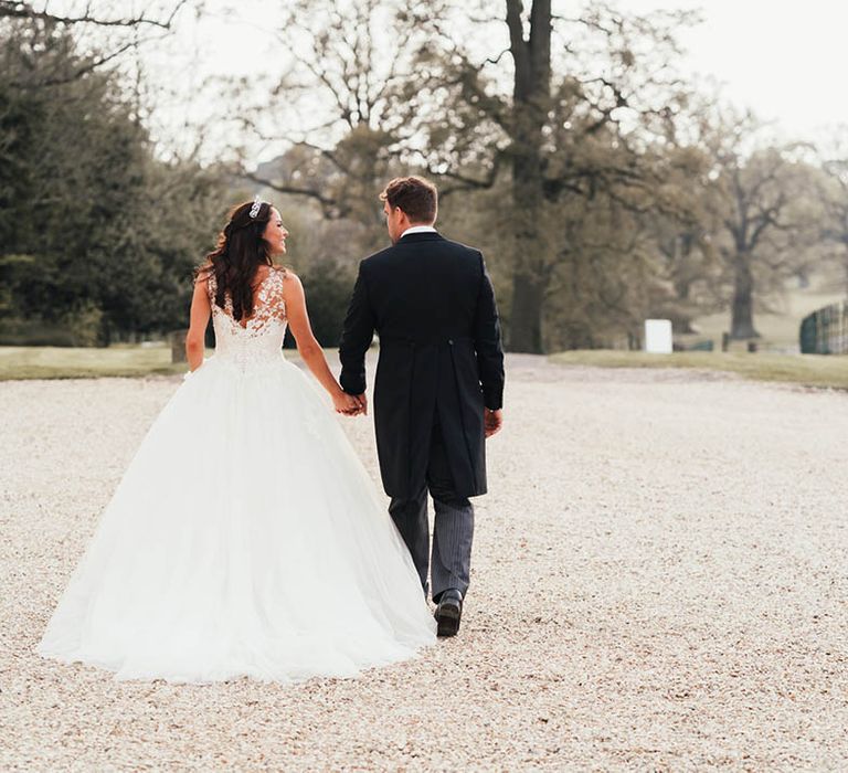 Fairytale wedding at Kirtlington Park House venue with bride in princess wedding dress and the groom in a morning suit 