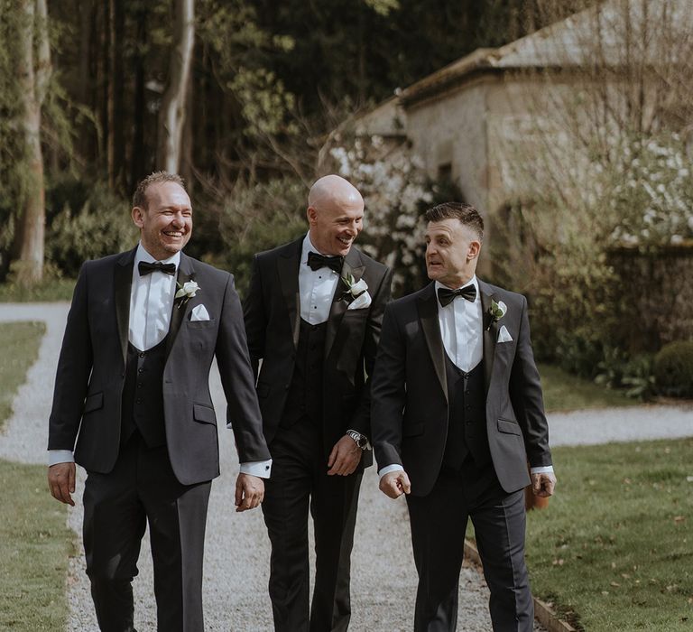 Groom and groomsmen in three piece black tie suits for classic wedding at Middleton Lodge 