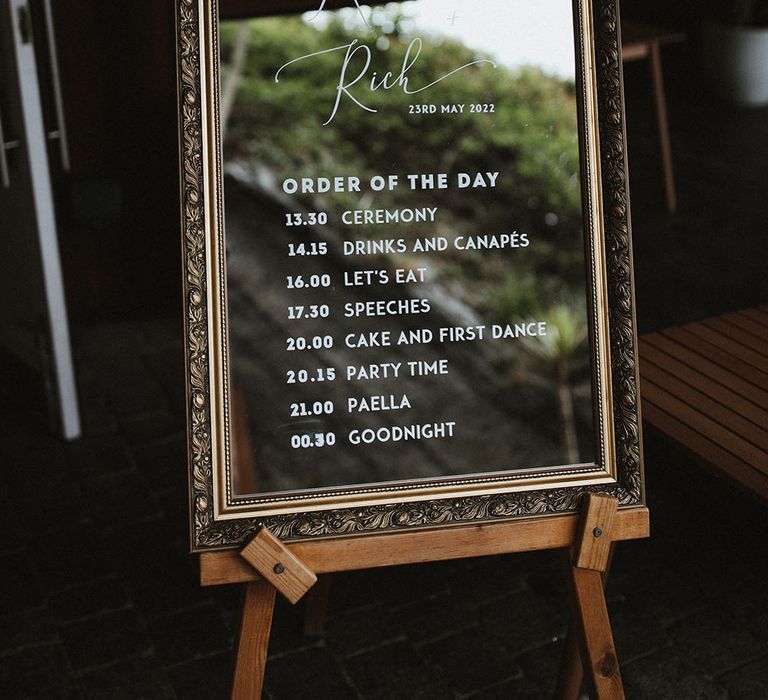 Gold framed mirror complete with white writing for Order Of The Day signage on wooden easel 