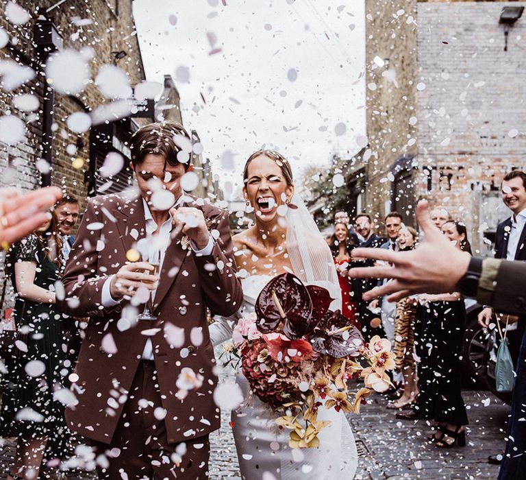 Bride and groom look happy as they have their confetti exit from their city wedding 