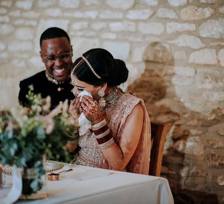 Bride cries during emotional wedding speeches at multicultural wedding