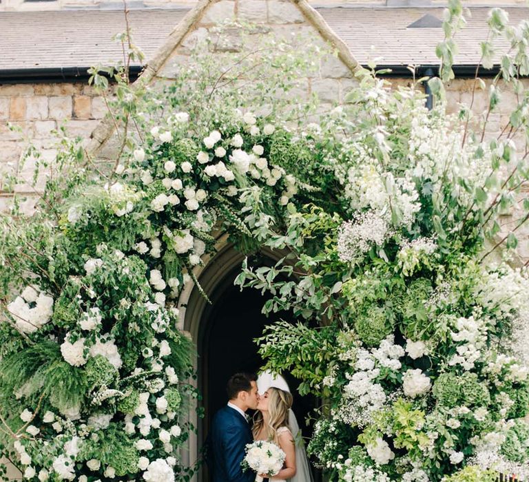 Huge and extravagant white and green wedding flower arch arrangement 