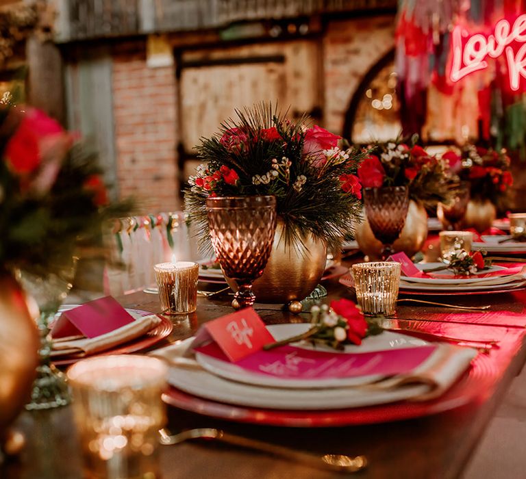 Contemporary, rustic wedding tablescape with hot pink plates, hot pink place names, gold candleholders and gold vase centrepieces with rose, peony and dried flower floral arrangements 