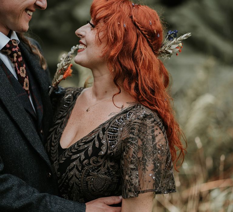 Bride in v-neck embellished short sleeve black wedding dress and dried flower hair accessory 