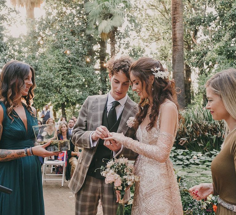 bride and groom exchanging wedding rings