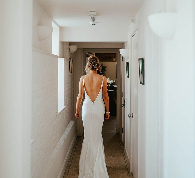 Bride in a Theia Couture low back satin wedding dress 