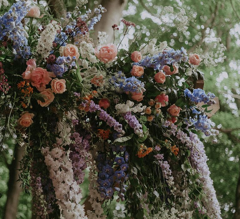 Close up of the stunning pink, white, and blue wildflower decoration for boho outdoor wedding