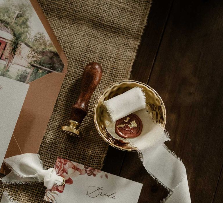 Botanical luxe wedding stationery place names with frayed white ribbon and red wax seals 