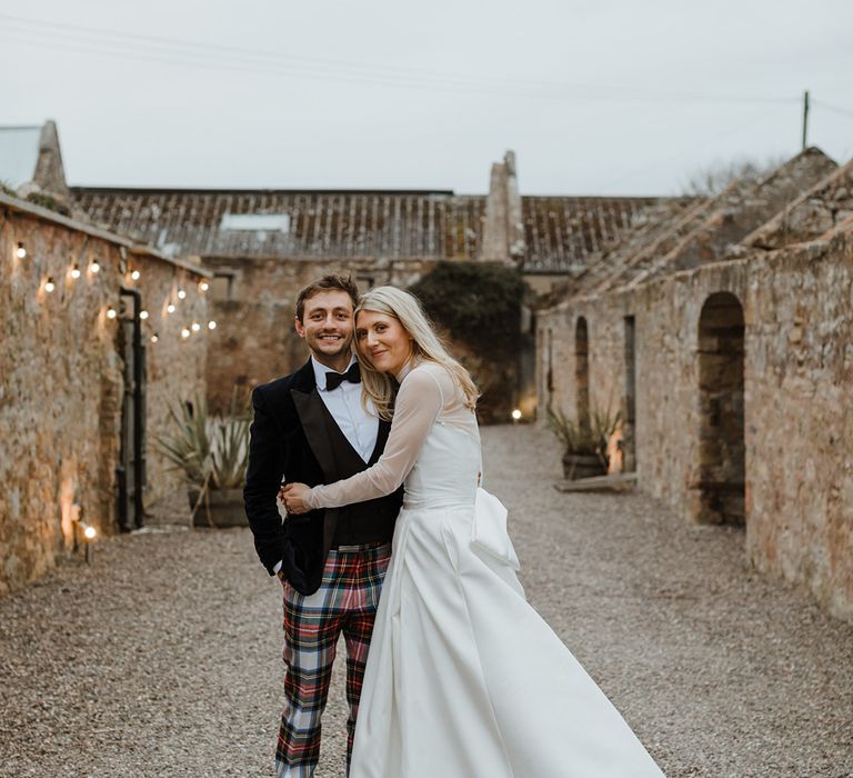 The Cowshed Crail wedding venue with the bride and groom posing together at the venue 