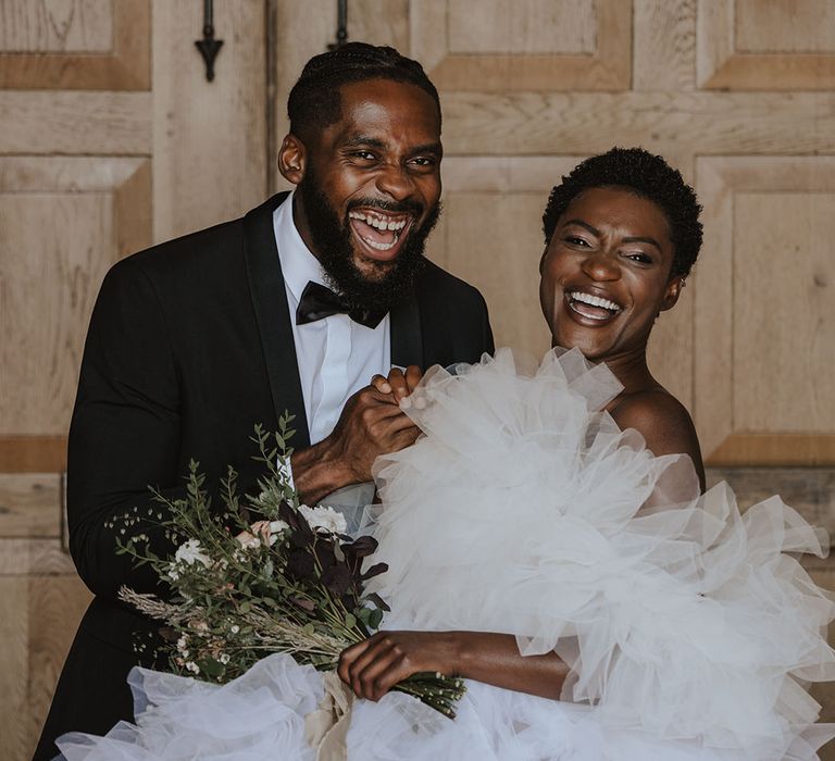 Norfolk Pentney Abbey wedding shoot with bride in off the shoulder tulle dress with groom in black tuxedo 