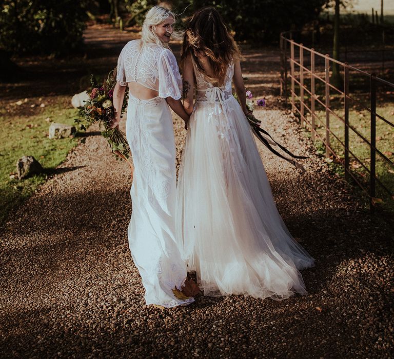 Bride in ASOS wedding dress with bride in a pre-loved secondhand wedding dress 