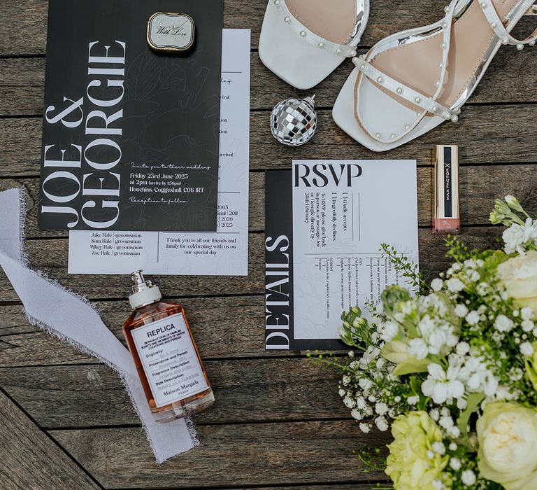 Monochrome black and white wedding stationery suite flatlay with the bride's wedding shoes 