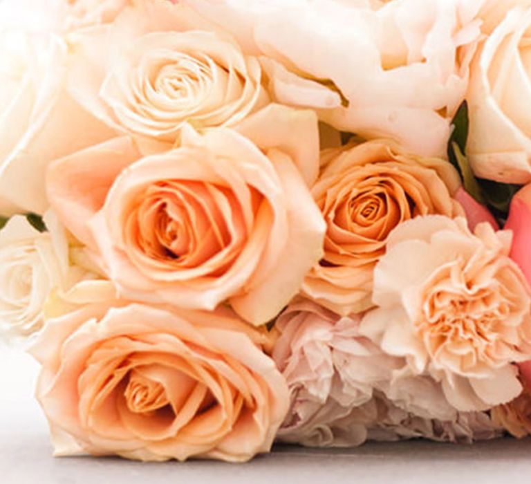 Spring wedding flowers including carnations, roses and peonies in peach tones for peach theme wedding