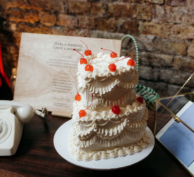 Heart shaped white retro iced wedding cake with cherries for retro glam wedding 