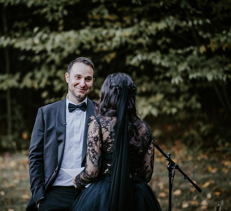 Groom in black tuxedo for gothic Pagan outdoor wedding ceremony 