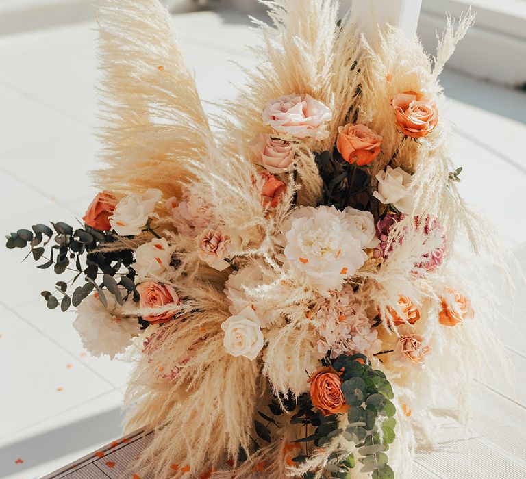 Pampas grass and roses boho wedding aisle flowers arrangement 