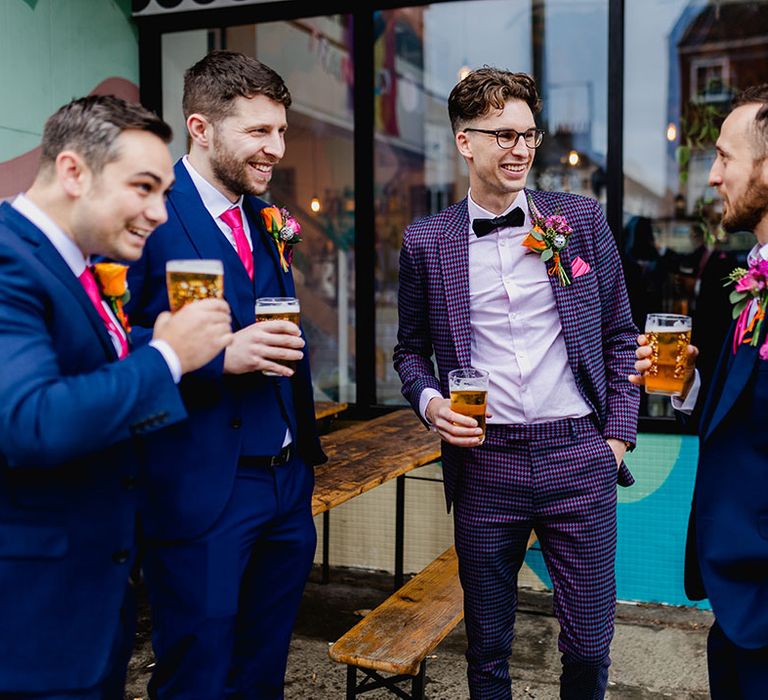 Groomsmen in bright blue wedding suits with groom in purple checkered suit from ASOS 