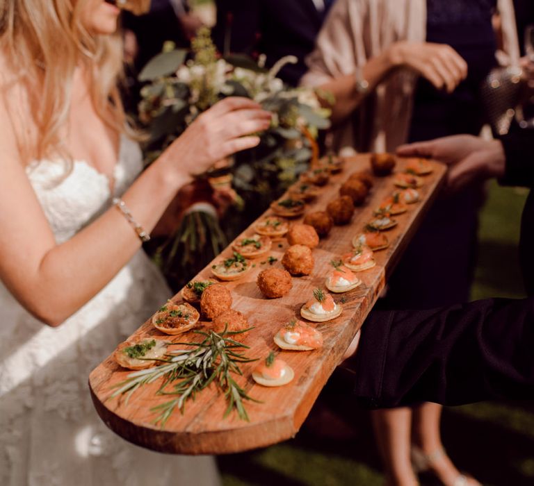 Bride tucks into delicious canapés at Larmer Tree Gardens Wedding