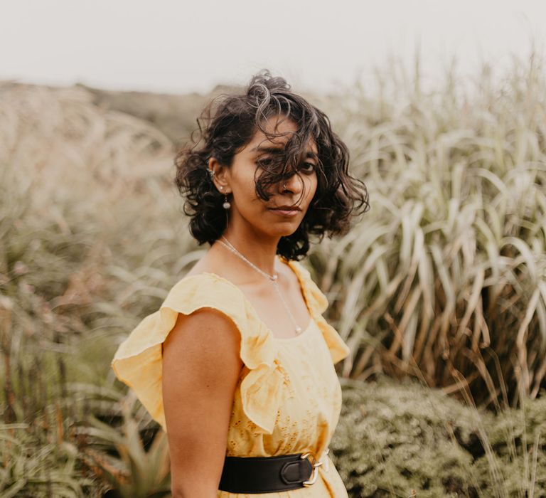 Bride in a yellow wedding dress at coastal elopement 