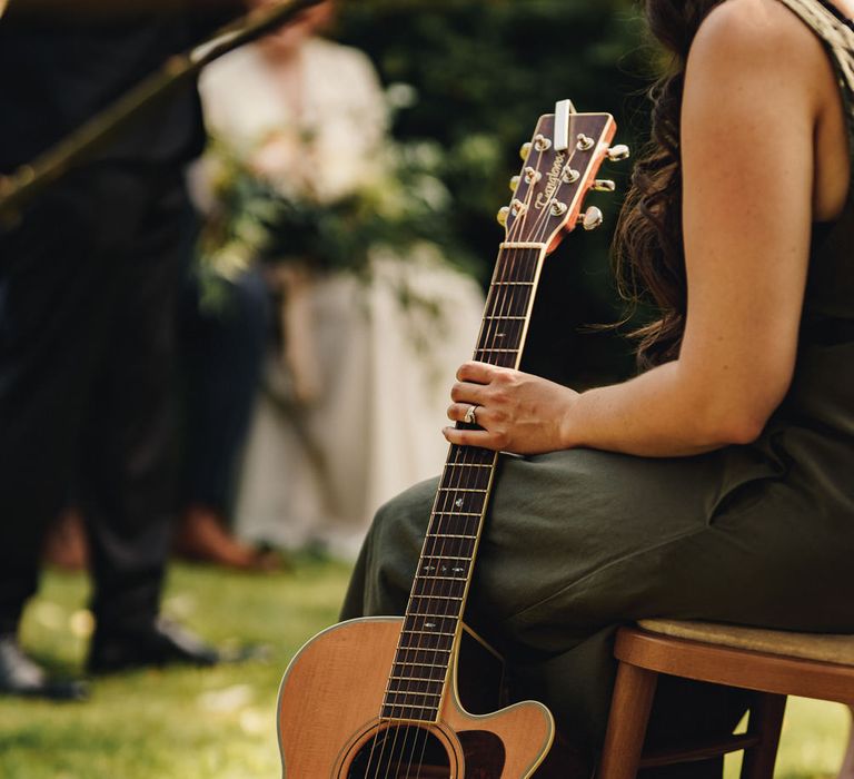 Guitarist at garden wedding ceremony 