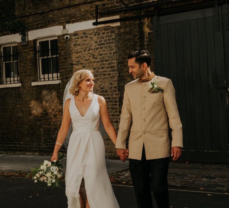 Bride and groom holding hands at micro wedding 