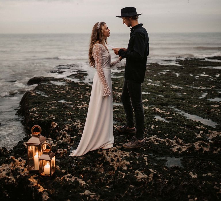 Groom reading his vows to his bride at an intimate beach elopement 