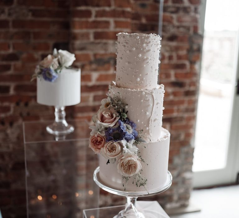 Three tier pastel wedding cake with floral and pearl detailing