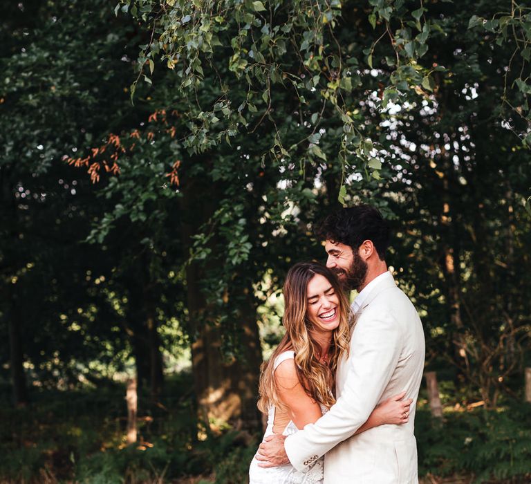 Bride & groom embrace in boho wedding inspiration 