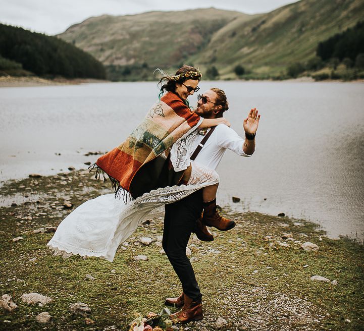 Groom lifts bride in the Lake District 