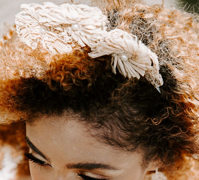 Black bride wears raffia crown and matching earrings 