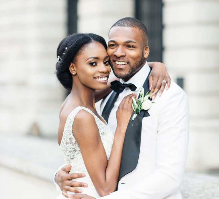 Bride & groom pose together outside 