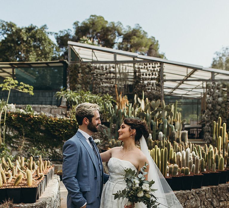 Bride and groom portrait in the Gibraltar Botanic Gardens with cactus plants 