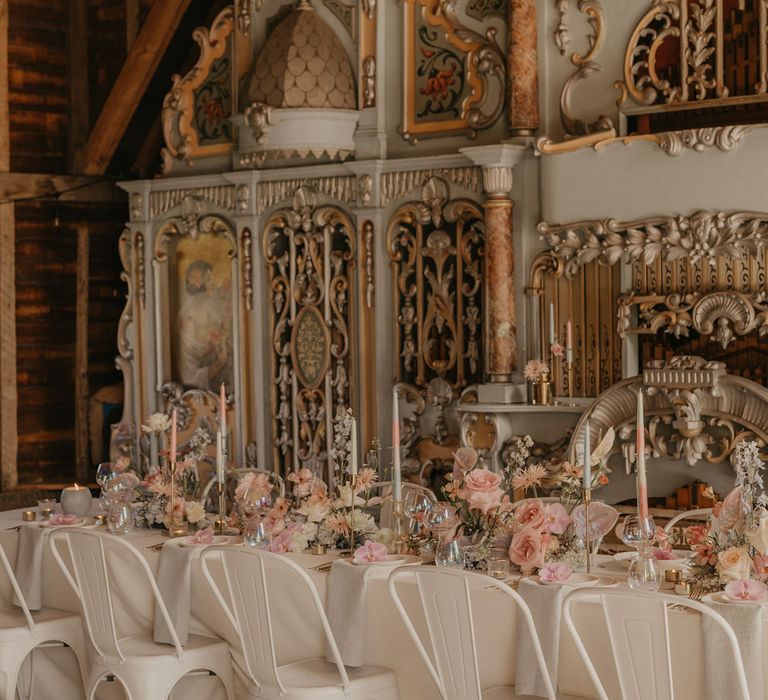 White industrial wedding chairs and tablecloth with pastel wedding decor and flowers 