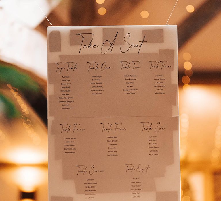 White seating chart hung with string 