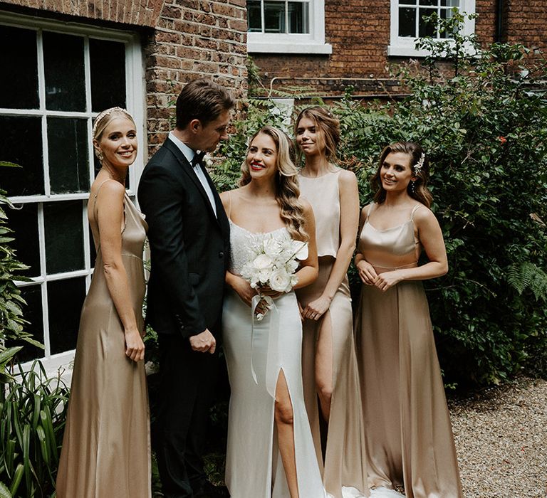 Bride, groom and bridesmaids in gold satin dresses by Constellation Ame 