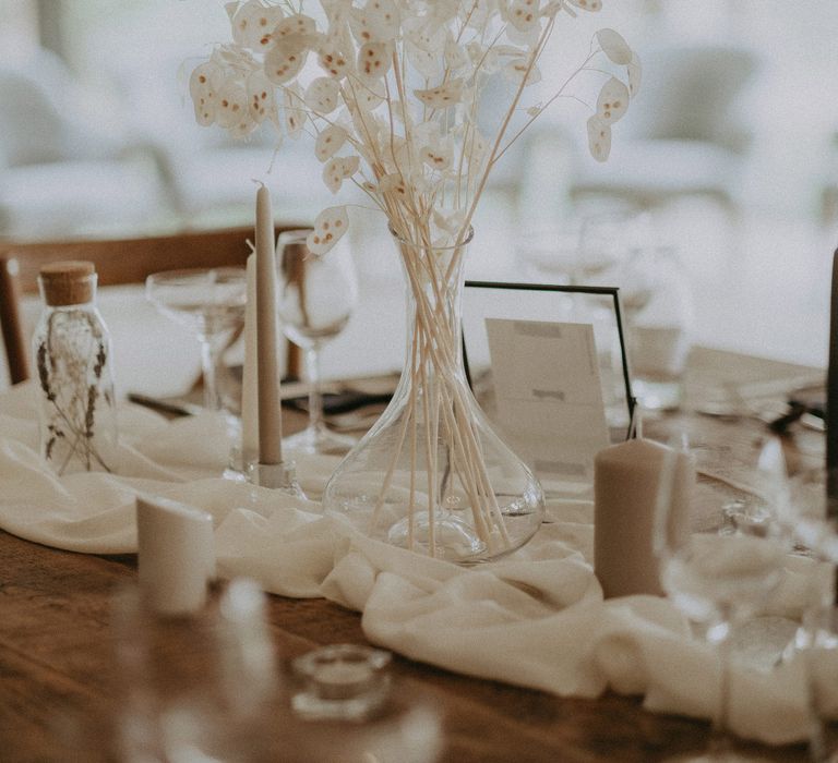 Dried white flower arrangements amongst neutral wedding table decor