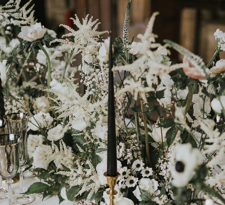 Black and white table wear and wedding flowers with gold accents 