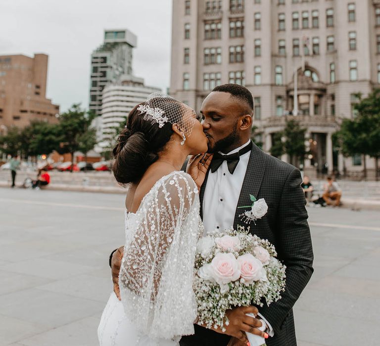 Bride & groom kiss on their wedding day during couples portraits