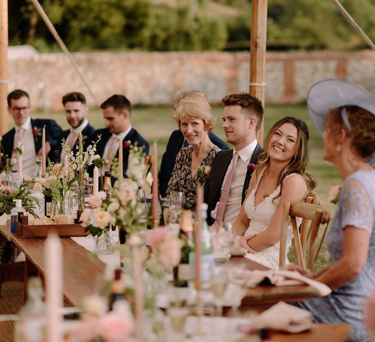 Bride and groom enjoy wedding speeches